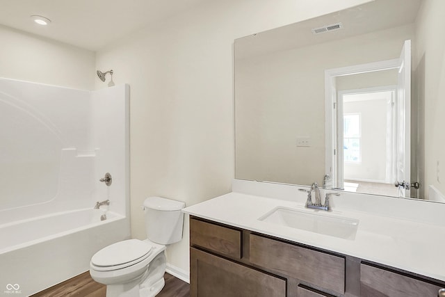 7168 Jackson Dr, Cumberland, IN 46229 - bathroom with visible vents, toilet, shower / bathing tub combination, wood finished floors, and vanity