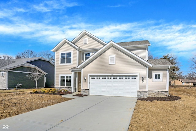 traditional-style home featuring stone siding, an attached garage, and driveway