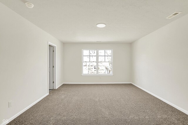 7168 Jackson Dr, Cumberland, IN 46229 - carpeted empty room featuring baseboards, visible vents, and a textured ceiling