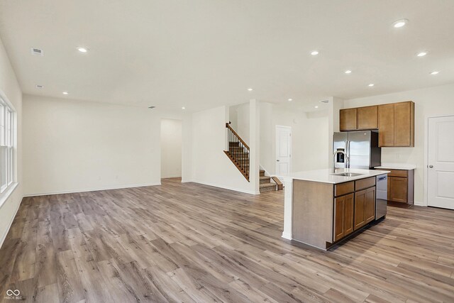 7168 Jackson Dr, Cumberland, IN 46229 - kitchen with recessed lighting, a sink, stainless steel appliances, light countertops, and light wood-type flooring