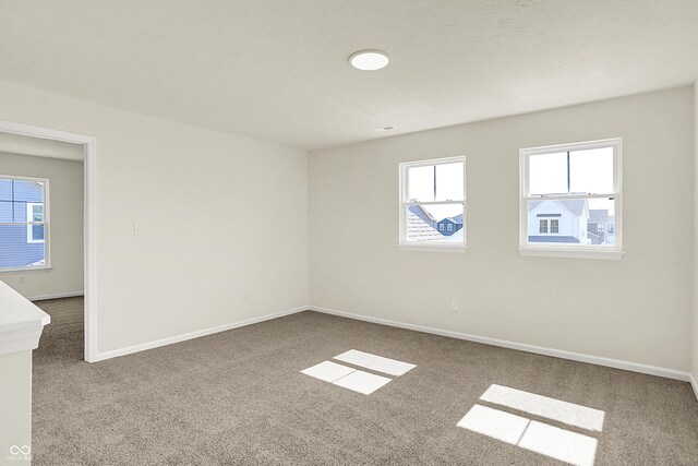 7168 Jackson Dr, Cumberland, IN 46229 - unfurnished room with a textured ceiling, baseboards, and carpet
