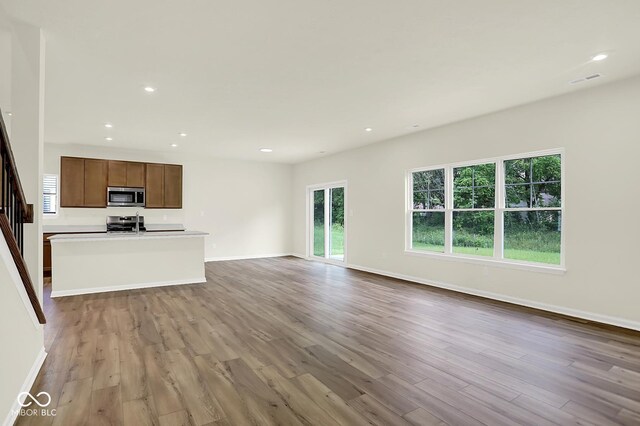 7168 Jackson Dr, Cumberland, IN 46229 - unfurnished living room featuring wood finished floors and recessed lighting