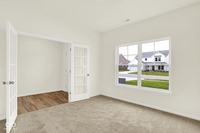 7168 Jackson Dr, Cumberland, IN 46229 - spare room featuring french doors and carpet
