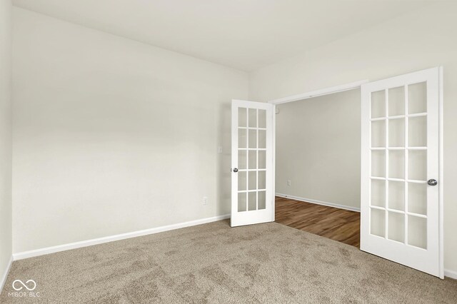 7168 Jackson Dr, Cumberland, IN 46229 - empty room with carpet flooring and french doors