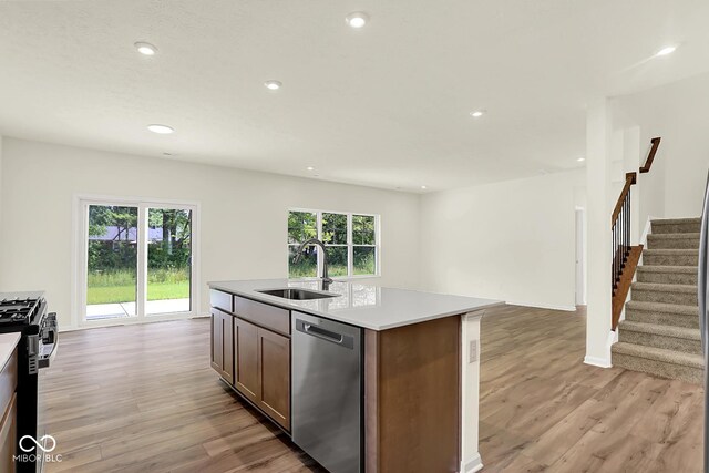 7168 Jackson Dr, Cumberland, IN 46229 - kitchen with stainless steel dishwasher, light wood finished floors, light countertops, gas range, and recessed lighting