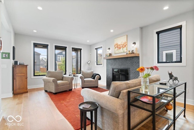 2026 Alvord St, Indianapolis, IN 46202 - living room featuring a glass covered fireplace, light wood-style flooring, recessed lighting, and baseboards