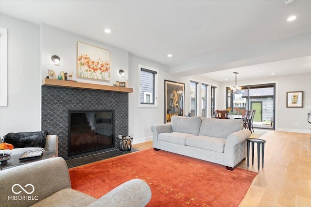 2026 Alvord St, Indianapolis, IN 46202 - living room with a tiled fireplace, recessed lighting, baseboards, and wood finished floors