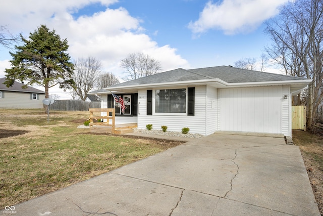 view of front of home with a front yard, concrete driveway, roof with shingles, and fence