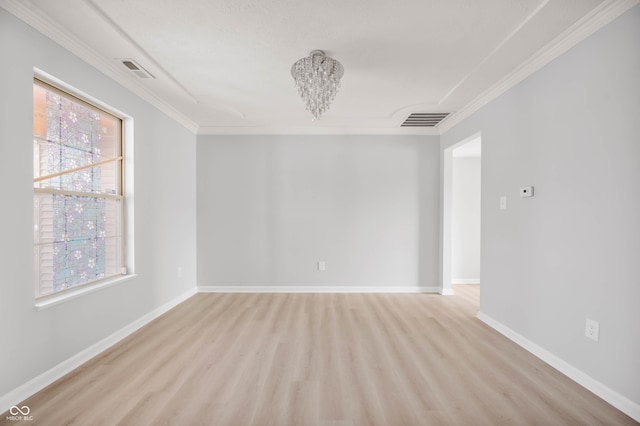 unfurnished room featuring light wood-type flooring, baseboards, visible vents, and crown molding