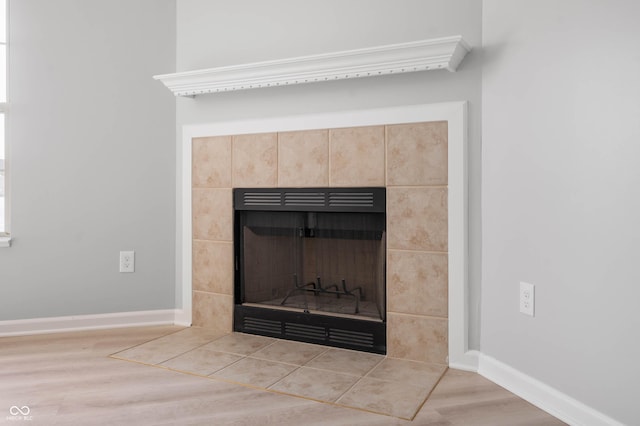 details with a fireplace, baseboards, and wood finished floors