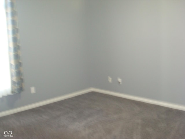 carpeted spare room with baseboards