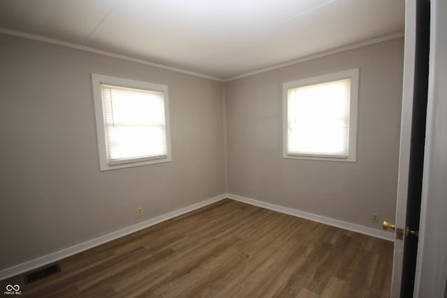 unfurnished room with ornamental molding, a wealth of natural light, and visible vents