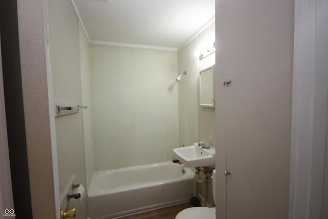 bathroom with crown molding, toilet, and shower / bathtub combination