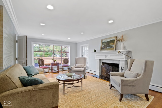 living area featuring wood finished floors, a baseboard radiator, a fireplace, recessed lighting, and ornamental molding