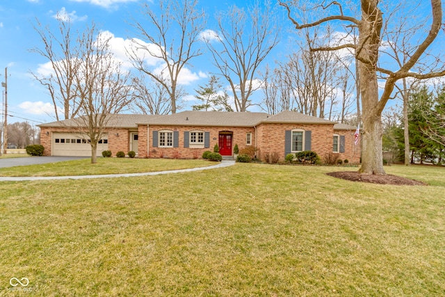 ranch-style house with a front lawn, brick siding, a garage, and driveway