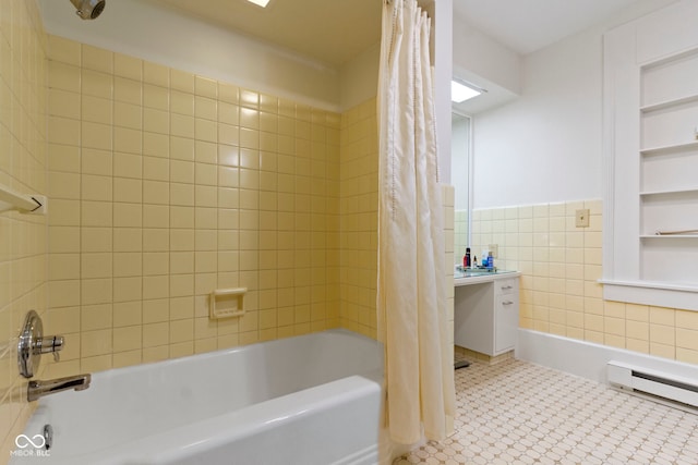 full bathroom featuring tile walls, built in features, shower / bathtub combination with curtain, and baseboard heating