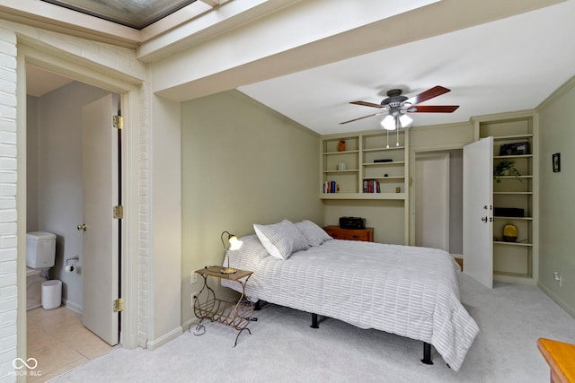 bedroom with light tile patterned floors, a ceiling fan, baseboards, and light carpet