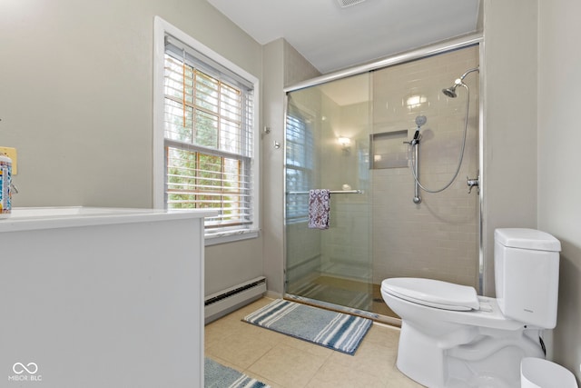 full bath with a baseboard radiator, toilet, a shower stall, and tile patterned flooring