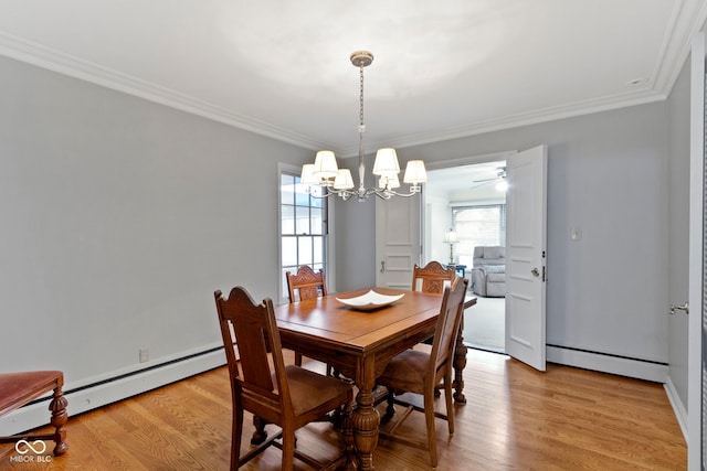 dining area featuring light wood-style floors, baseboard heating, and ornamental molding