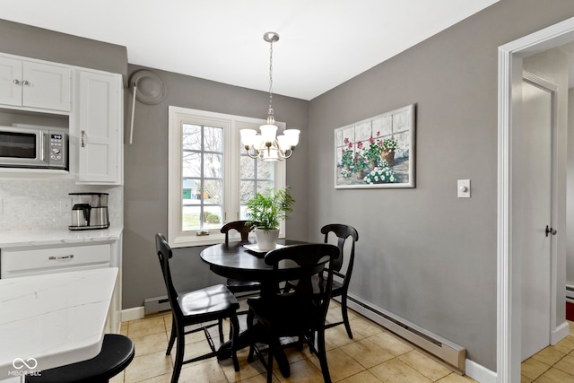 dining space with baseboard heating, an inviting chandelier, baseboards, and a baseboard radiator