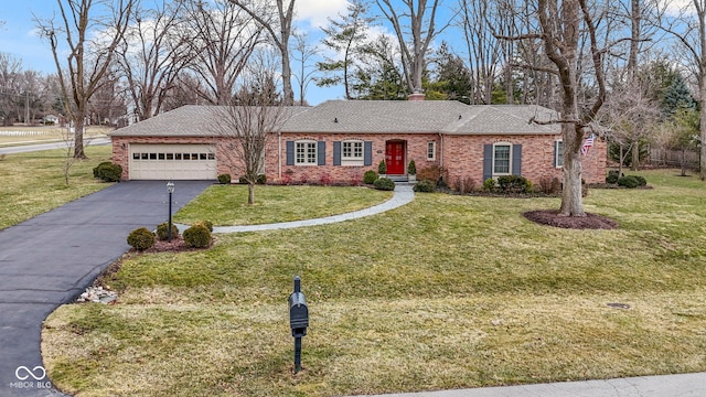 ranch-style house featuring aphalt driveway, a front lawn, a garage, and brick siding