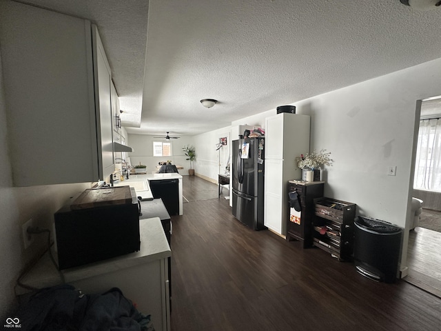 kitchen with a textured ceiling, ceiling fan, light countertops, dark wood-style floors, and black appliances