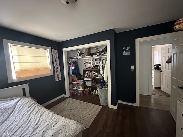 bedroom with a closet, baseboards, and wood finished floors