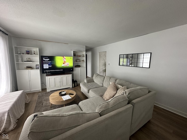 living area with a textured ceiling and wood finished floors