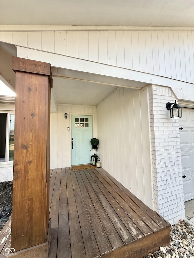 wooden terrace with a garage