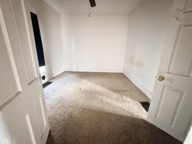 spare room with visible vents, baseboards, carpet, and ceiling fan