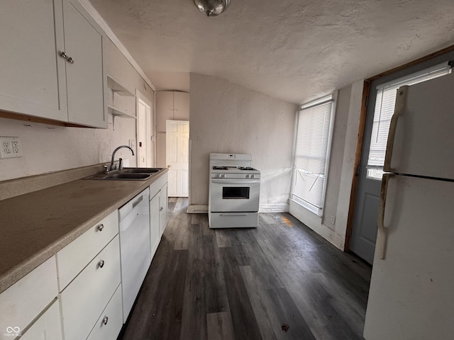 kitchen with dark wood finished floors, white appliances, white cabinets, and a sink