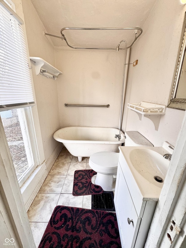 bathroom featuring vanity, tile patterned floors, and toilet