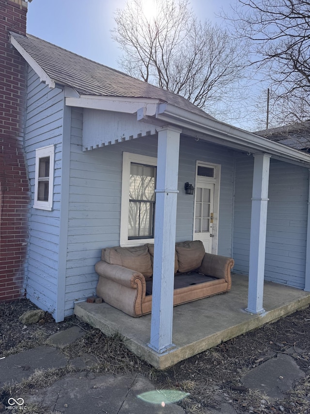 entrance to property with roof with shingles