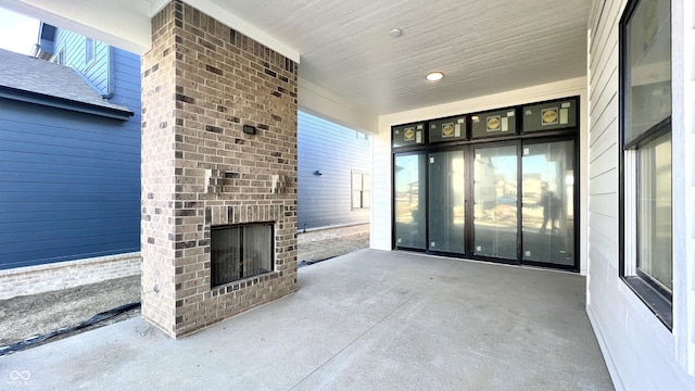 view of patio / terrace with an outdoor brick fireplace