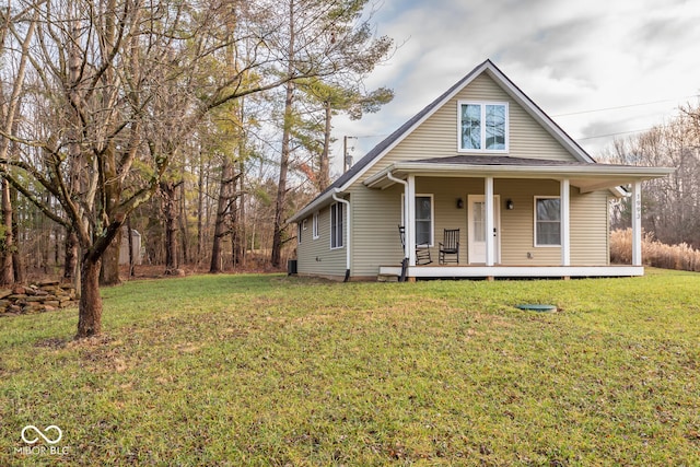 view of front of house with covered porch and a front lawn