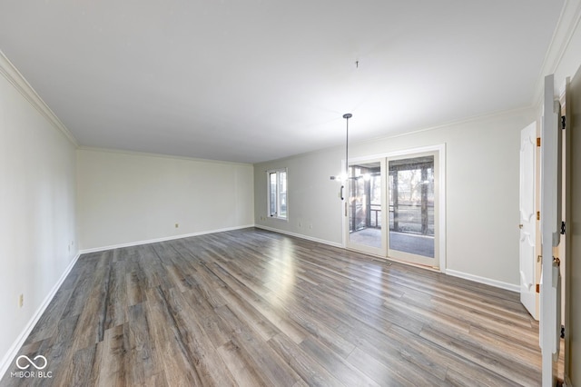 interior space with baseboards, wood finished floors, and ornamental molding