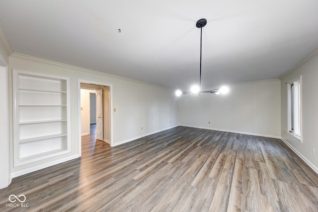 unfurnished room featuring built in shelves, crown molding, baseboards, and wood finished floors