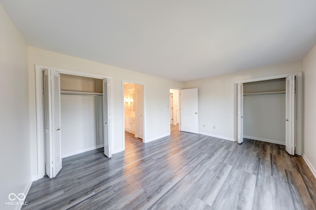 unfurnished bedroom featuring baseboards and wood finished floors