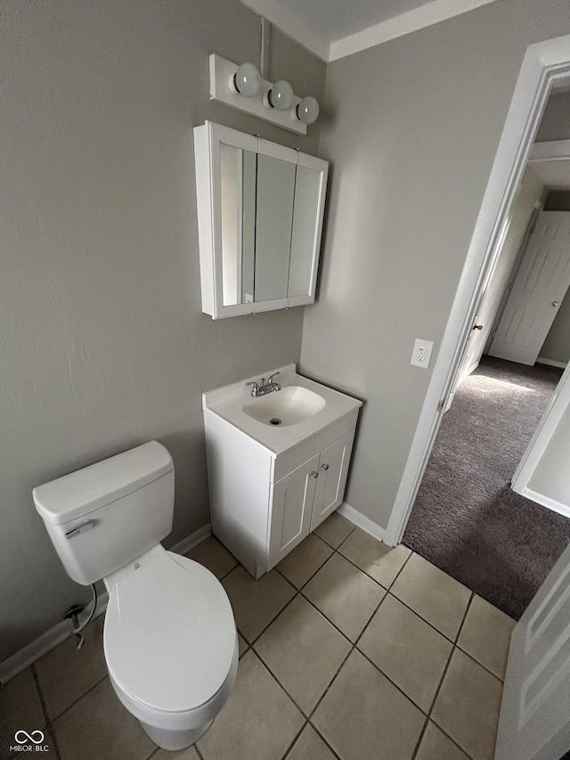 half bath featuring toilet, tile patterned flooring, baseboards, and vanity