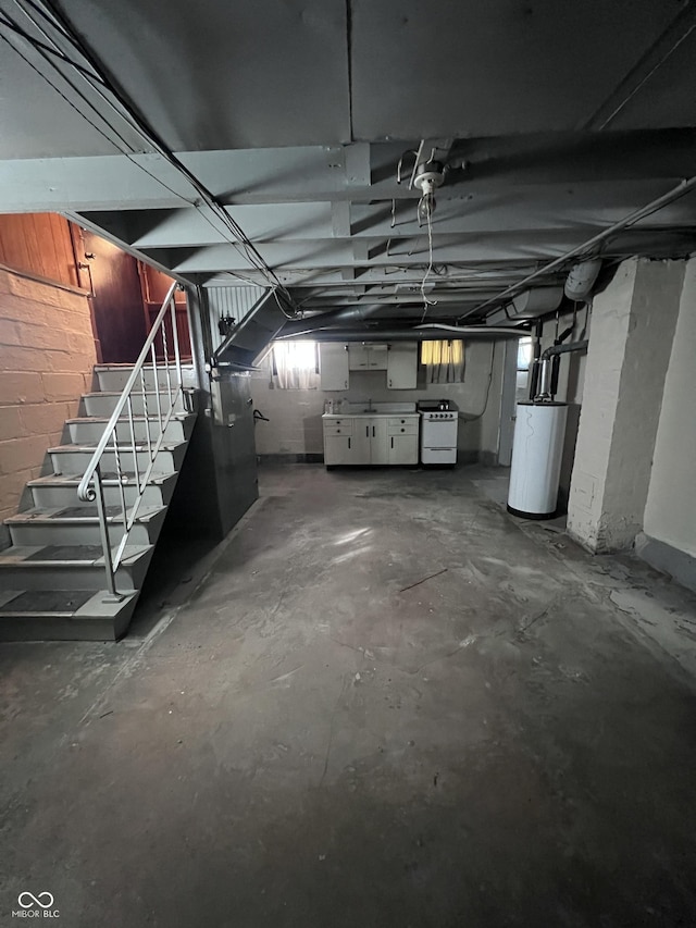 below grade area featuring stairs, washer / clothes dryer, and gas water heater