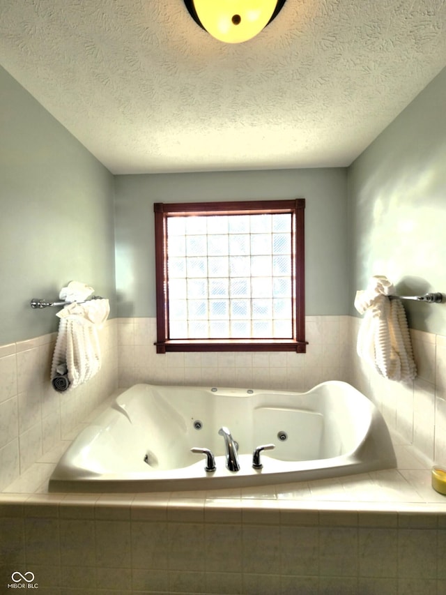 bathroom with a tub with jets