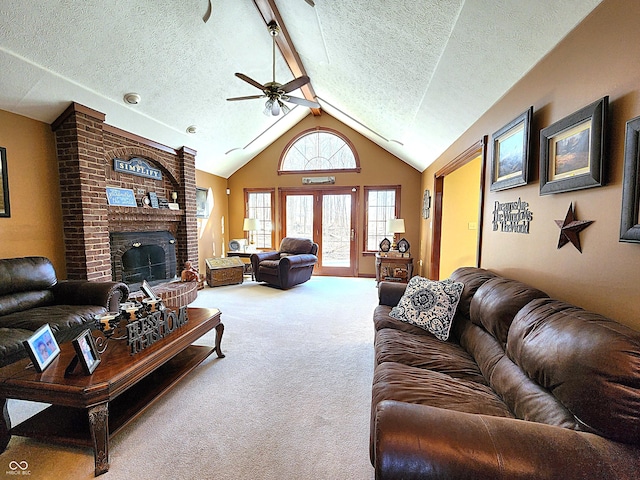 living area featuring a brick fireplace, vaulted ceiling with beams, carpet, a textured ceiling, and a ceiling fan