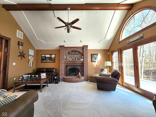 living area with carpet, visible vents, beam ceiling, ceiling fan, and a brick fireplace