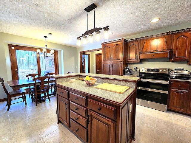 kitchen featuring double oven range, a center island, custom exhaust hood, a chandelier, and hanging light fixtures