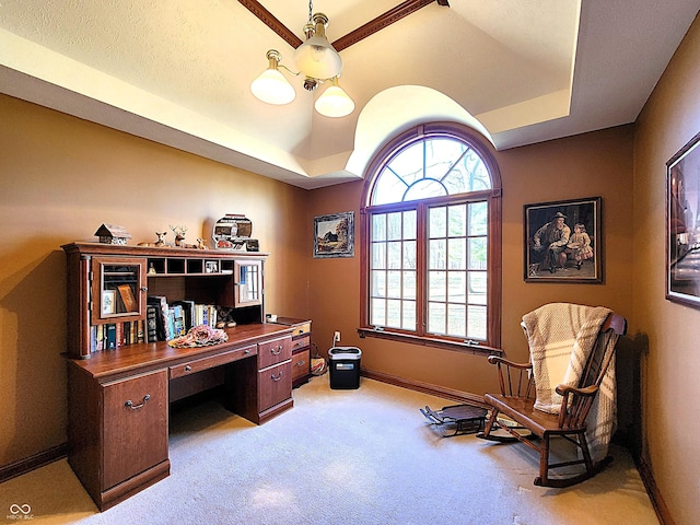 home office with a tray ceiling, carpet flooring, and baseboards