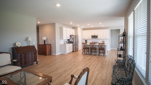 2349 S Copperstone Dr, New Palestine, IN 46163 - living area with baseboards, recessed lighting, and light wood-style floors
