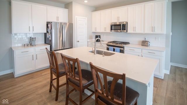 2349 S Copperstone Dr, New Palestine, IN 46163 - kitchen featuring light wood-style flooring, a sink, recessed lighting, and appliances with stainless steel finishes