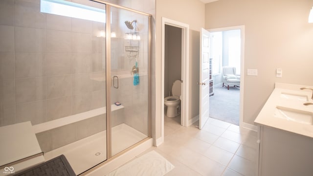 2349 S Copperstone Dr, New Palestine, IN 46163 - full bathroom featuring toilet, tile patterned floors, a stall shower, double vanity, and baseboards
