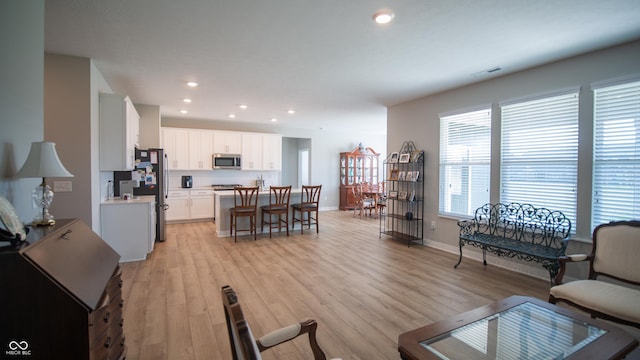 2349 S Copperstone Dr, New Palestine, IN 46163 - living room with light wood-type flooring, baseboards, visible vents, and recessed lighting