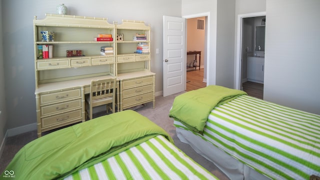 2349 S Copperstone Dr, New Palestine, IN 46163 - bedroom with baseboards, ensuite bathroom, visible vents, and carpet floors